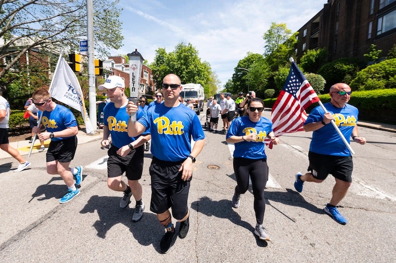 Pitt Police officers running down 5th avenue