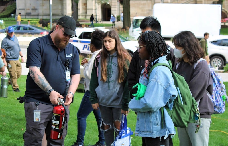 PSEM staff demonstrating how to use a fire extinguisher