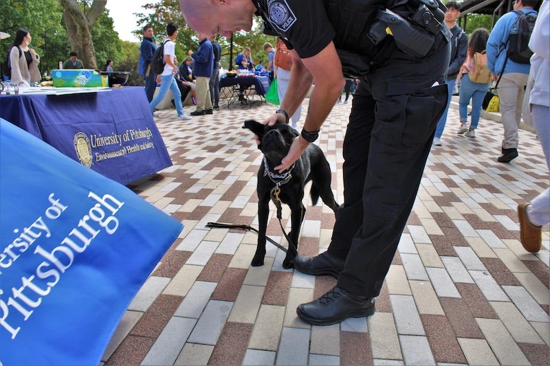 Pitt Police officer petting a dog