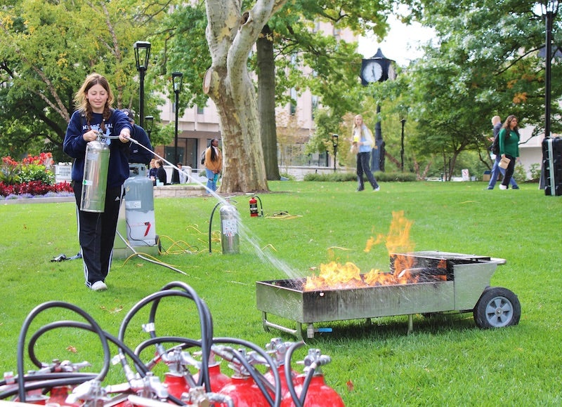 student putting out a fire