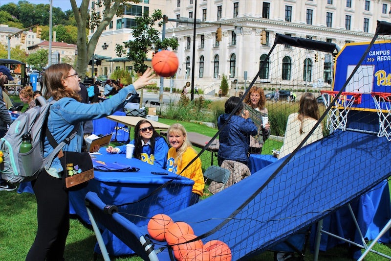 student playing mini-basketball