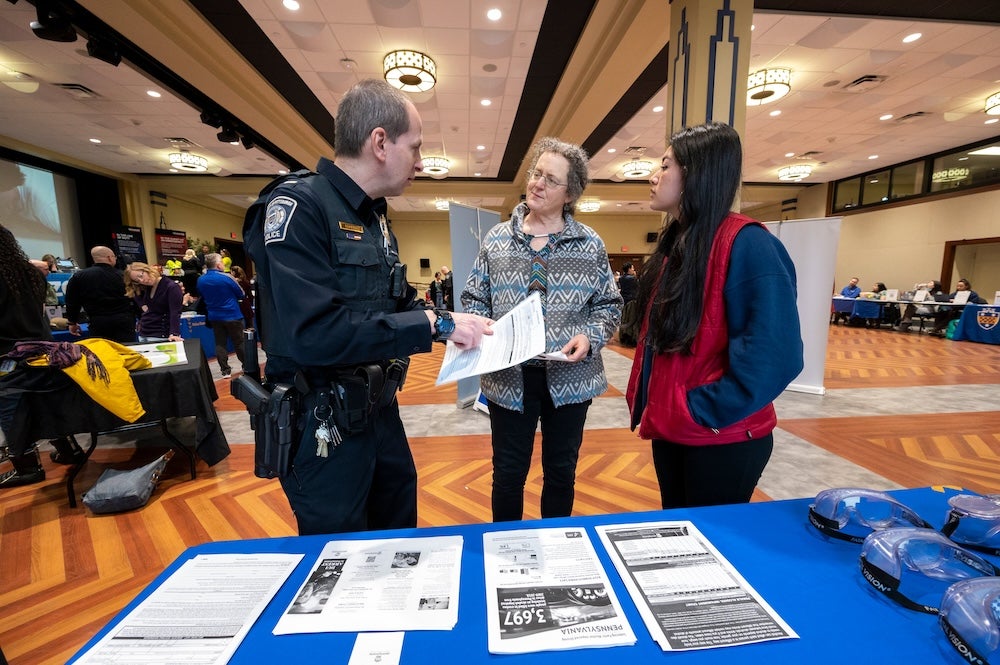 people talking to a Pitt Police Officer