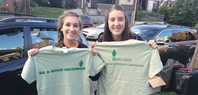 Be a Good Neighbor-girls holding t.shirts