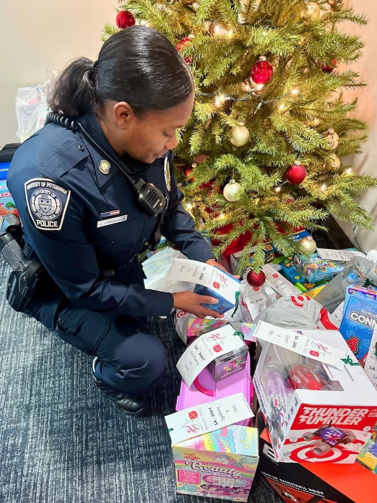 Pitt Police Officer holding a present