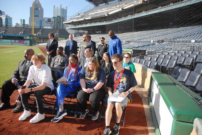 People sitting on the PNC Park baseball field