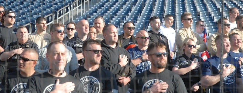 crowd listening to the national anthem