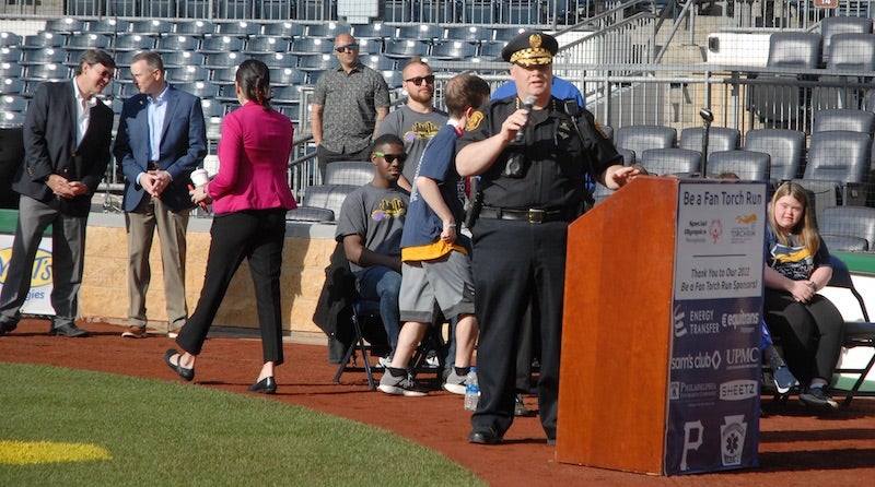 Police officer speaking at a podium