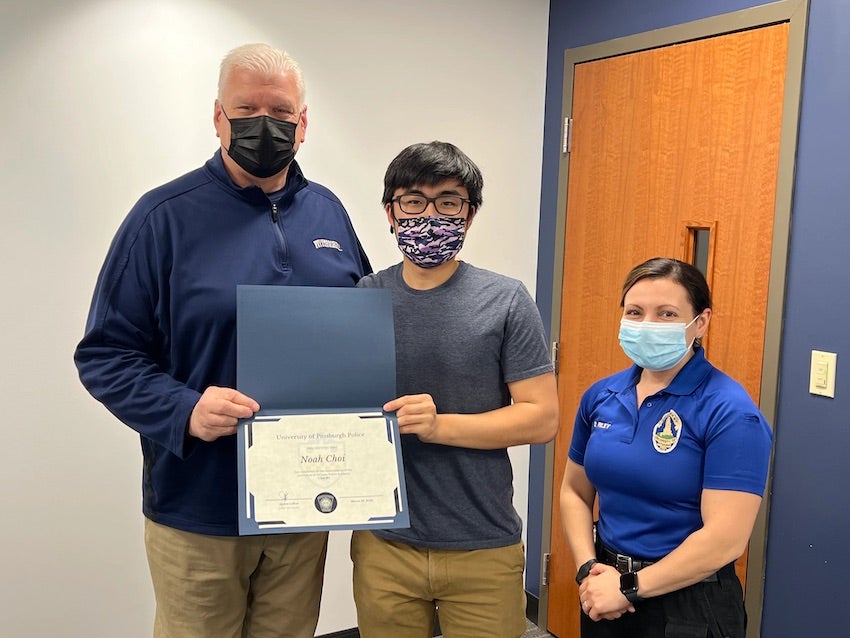 Noah Choi receiving graduation certificate