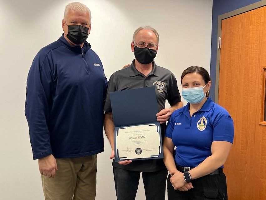 Blaine Walker receives his graduation certificate