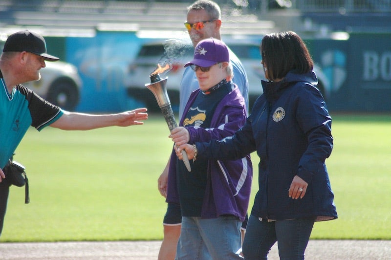 Two people holding the Special Olympics Torch