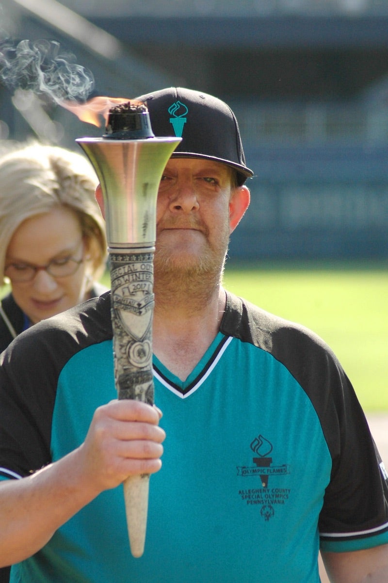 Person walking with the Special Olympics Torch