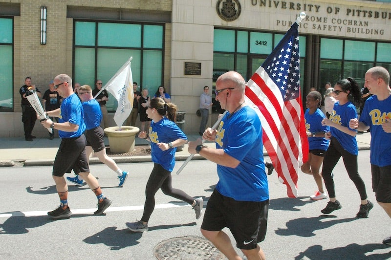 Pitt Police officers running up Forbes avenue