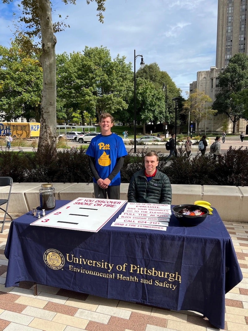 two attendants at the "If you discover a smoke or fire" table