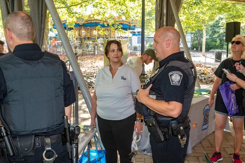 woman talking with a Pitt Police Officer