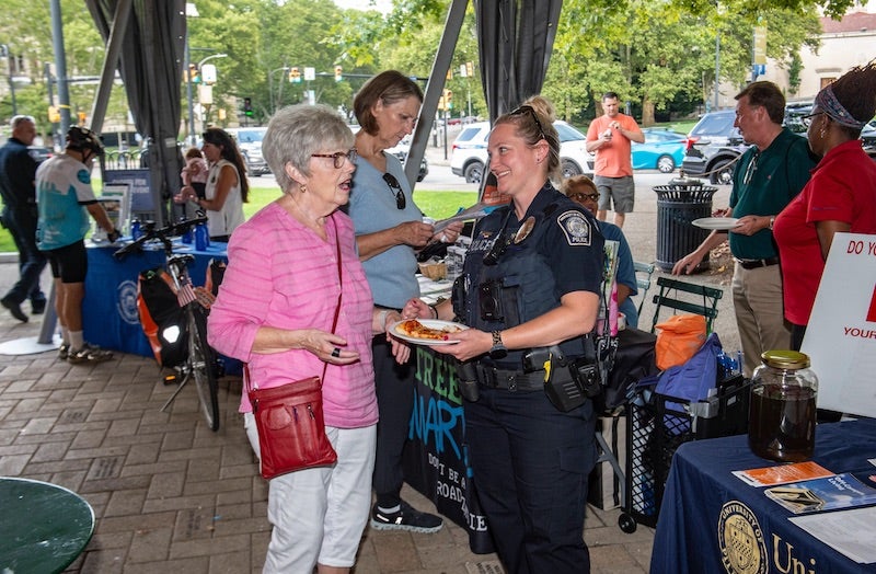 woman talking with a Pitt Police Officer