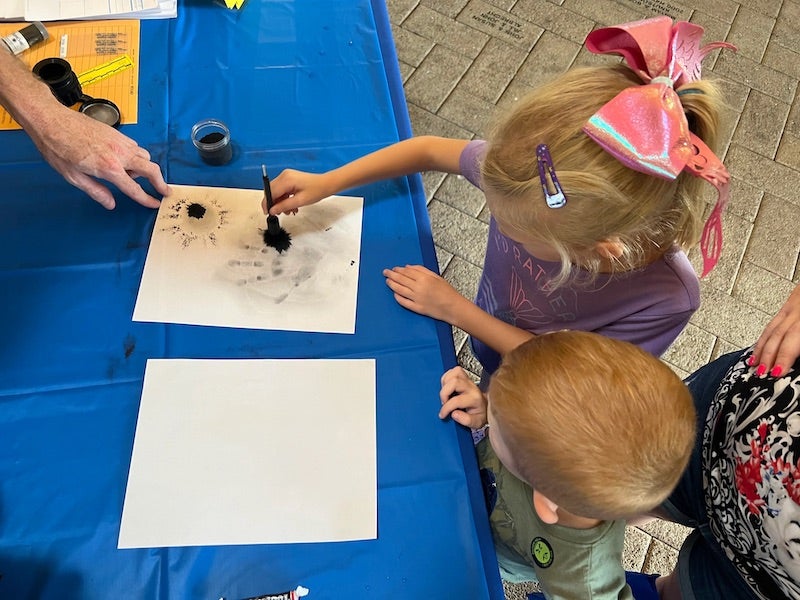 child drawing on paper