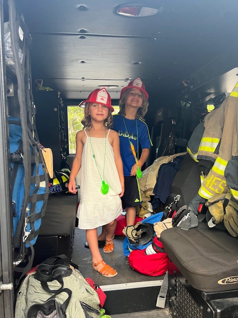 two children inside a firetruck