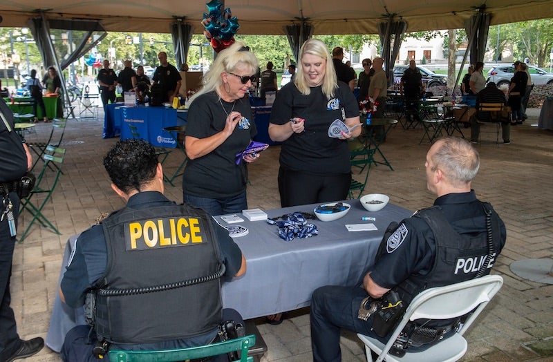 two people interacting with police officers