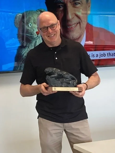 Rick Troy holding a Pitt Panther statue