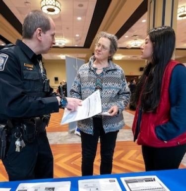 people talking to a Pitt Police Officer