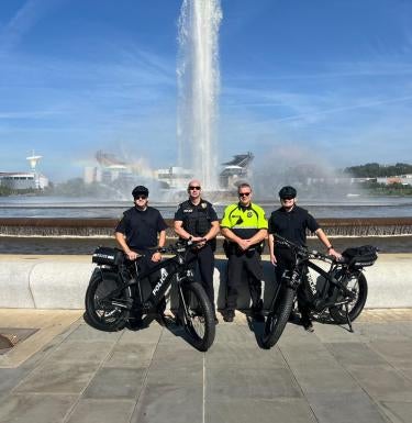 UPPD bike officers standing in front of fountain