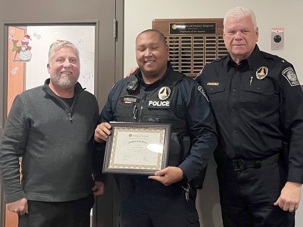 Officer Terry Stoudmire with Ted Fritz and Chief Jim Loftus. 